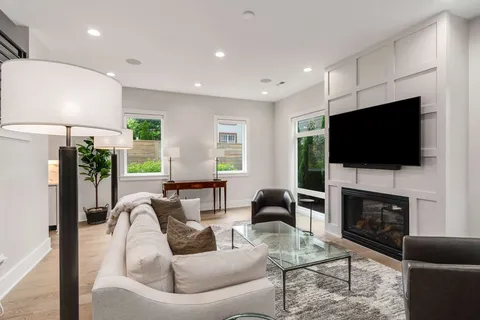 a dining room with furniture a chandelier and wooden floor