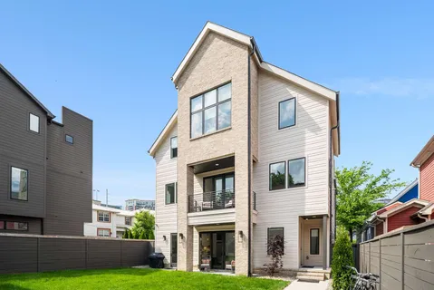 a aerial view of multiple houses with a yard