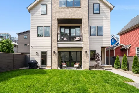an aerial view of residential houses with outdoor space and parking