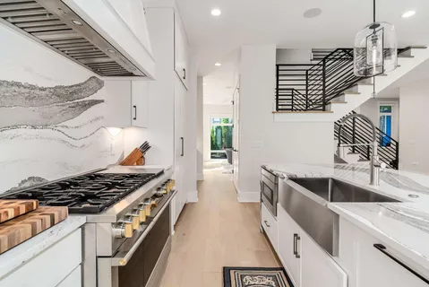 a kitchen with granite countertop a stove and a sink