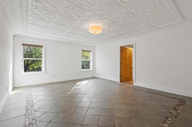 an empty room with windows and entrance