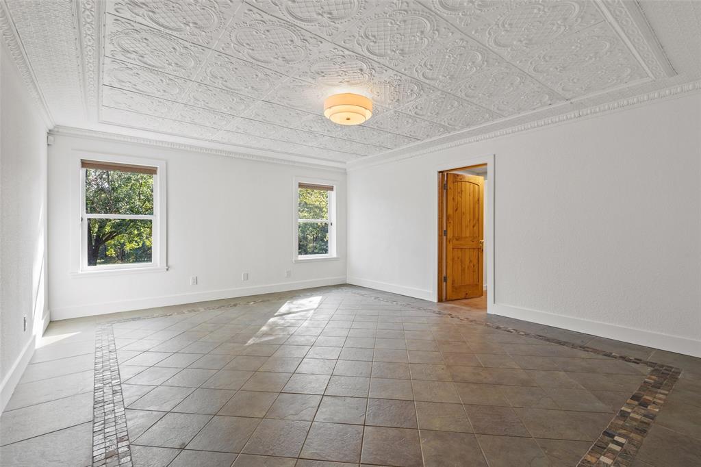 411 Hidden Meadows Lane Denison, TX 75021 - Photo 11 of 40 an empty room with windows and entrance