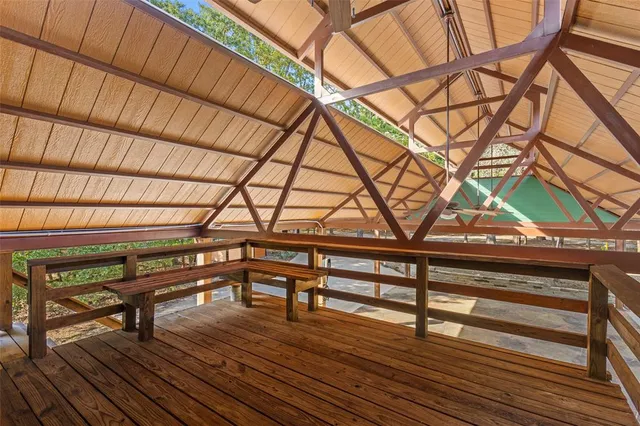 a backyard of a house with barbeque oven table and chairs