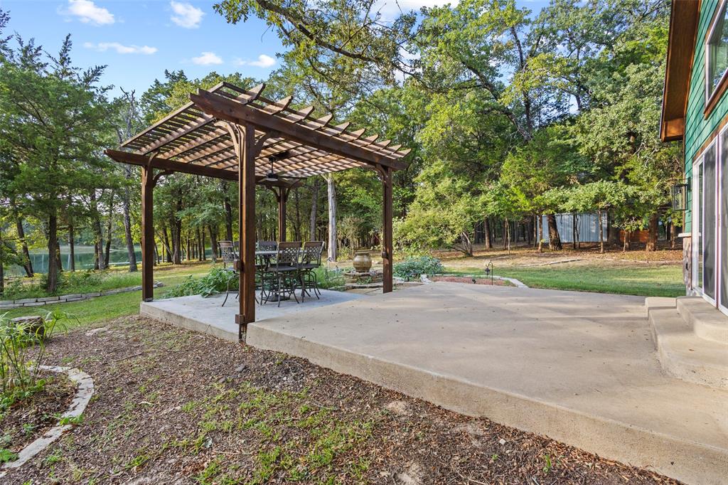 411 Hidden Meadows Lane Denison, TX 75021 - Photo 18 of 40 a backyard of a house with barbeque oven table and chairs