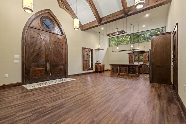 a kitchen with stainless steel appliances granite countertop a refrigerator a stove and a wooden floors