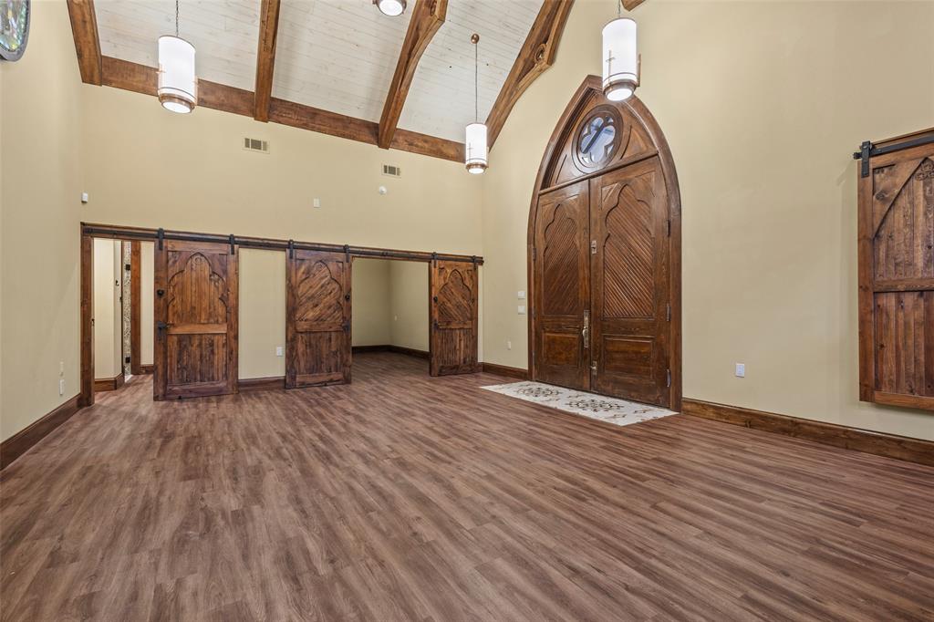 411 Hidden Meadows Lane Denison, TX 75021 - Photo 26 of 40 a view of an empty room with wooden floor and a window