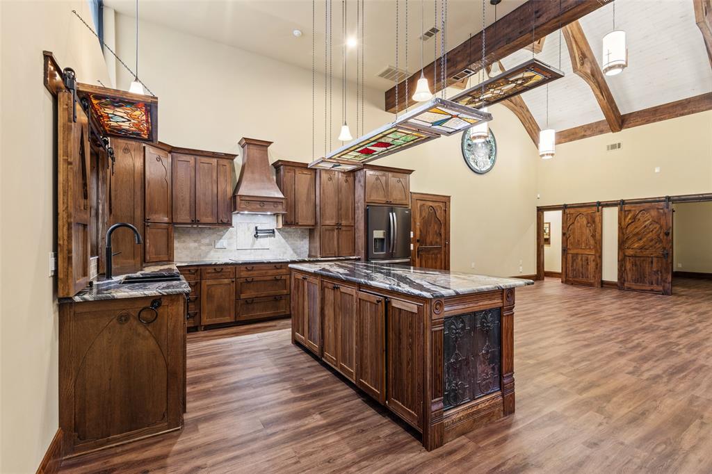 411 Hidden Meadows Lane Denison, TX 75021 - Photo 28 of 40 a kitchen with stainless steel appliances granite countertop a stove and a wooden floors