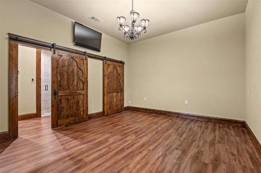 411 Hidden Meadows Lane Denison, TX 75021 - Photo 29 of 40 a view of a room with wooden floor closet and windows