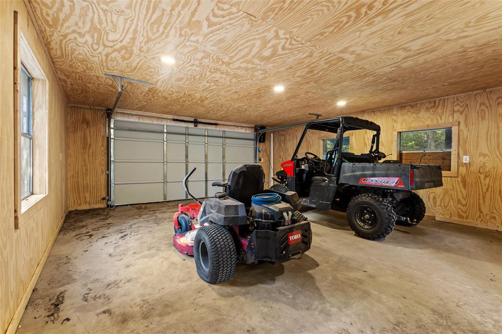 411 Hidden Meadows Lane Denison, TX 75021 - Photo 31 of 40 a garage with a car and a car parked