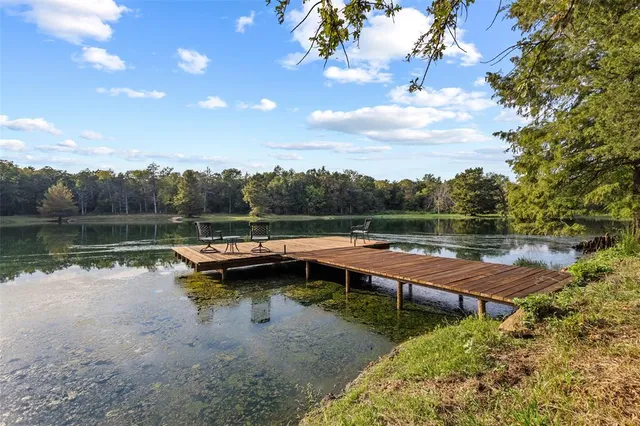 an aerial view of a city with lots of residential buildings and mountain view in back