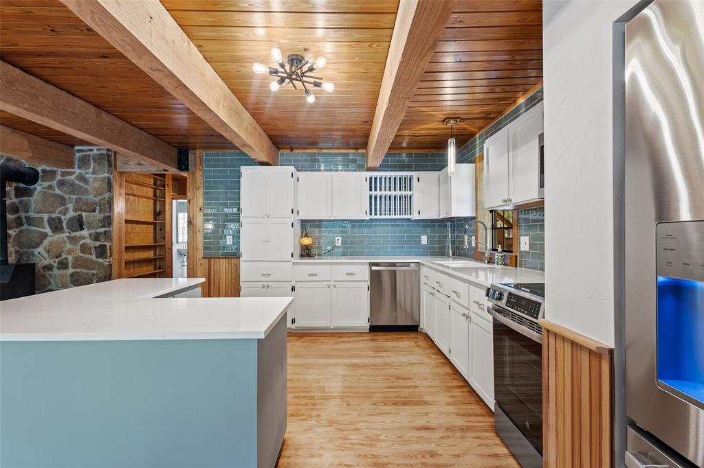 411 Hidden Meadows Lane Denison, TX 75021 - Photo 10 of 40 a kitchen with stainless steel appliances granite countertop a sink a stove and a refrigerator
