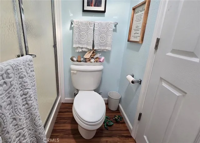 a white toilet sitting next to a small bathroom