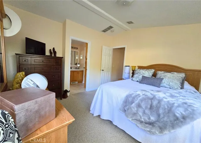 a bedroom with a bed and dresser