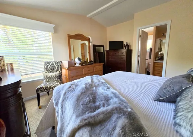 a bedroom with a bed and large mirror