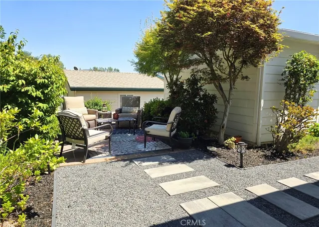 a view of backyard with outdoor seating and plants