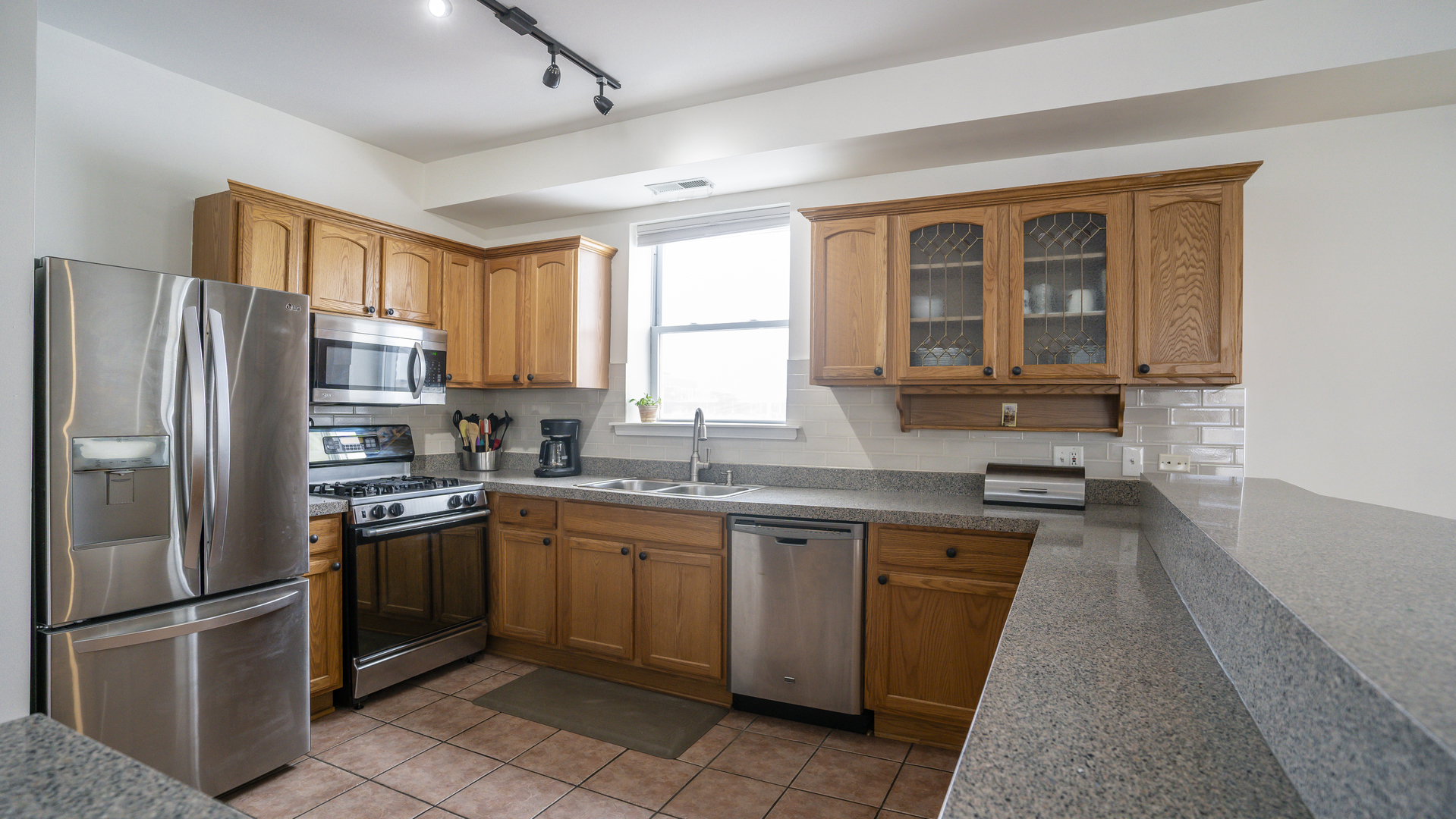 4660 North Spaulding Avenue, Unit 3 Chicago, IL 60625 - Photo 2 of 29 a kitchen with stainless steel appliances granite countertop a refrigerator stove top oven and sink