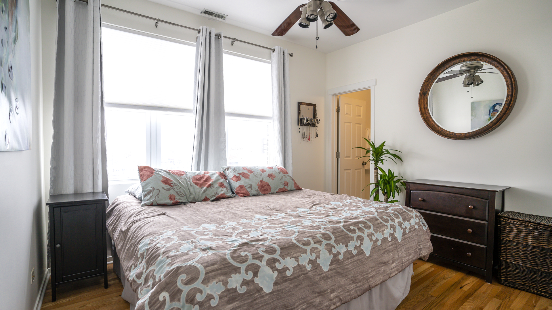 4660 North Spaulding Avenue, Unit 3 Chicago, IL 60625 - Photo 18 of 29 a bedroom with a bed and dresser with mirror