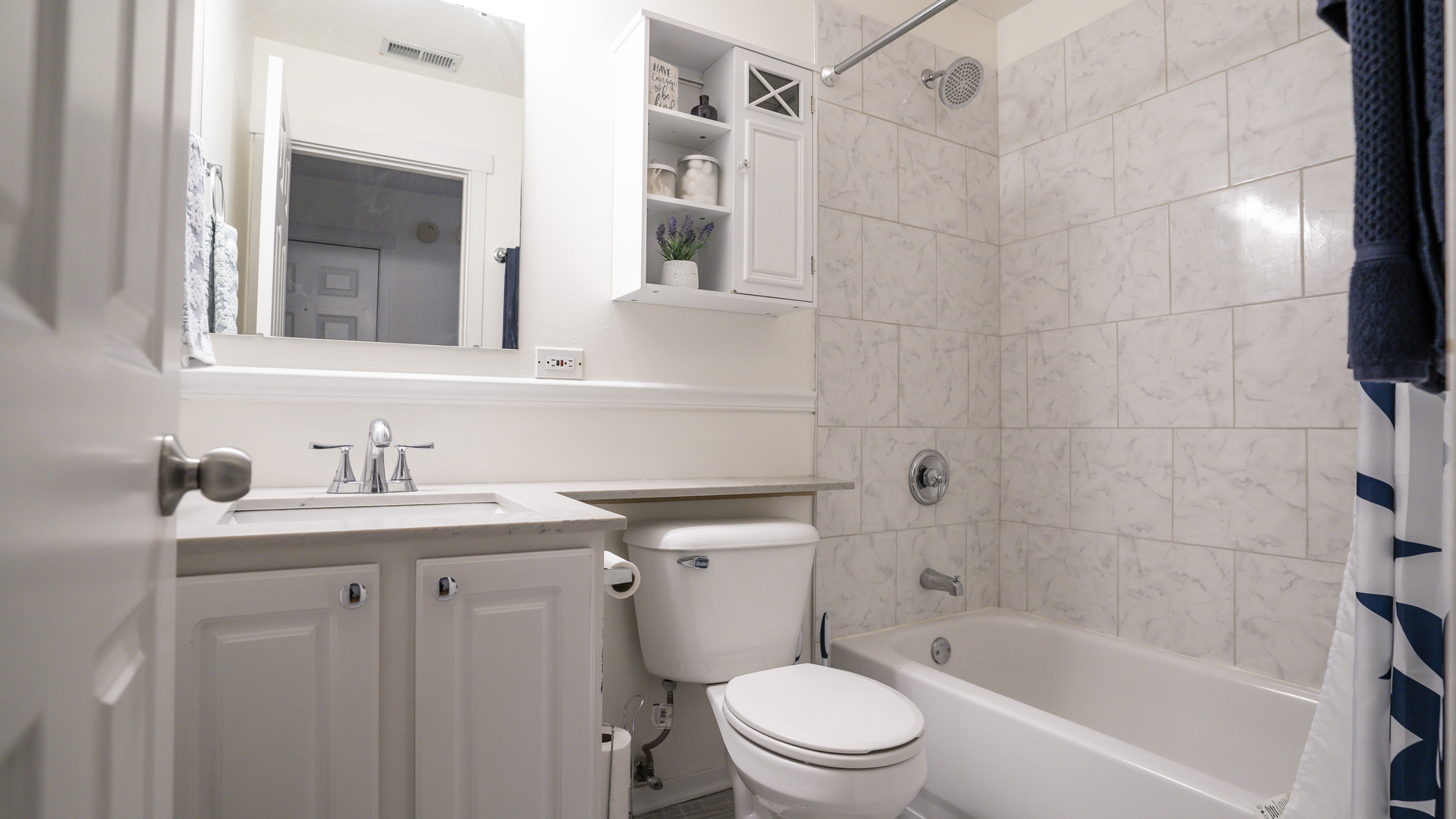 4660 North Spaulding Avenue, Unit 3 Chicago, IL 60625 - Photo 25 of 29 a bathroom with a granite countertop sink a toilet and shower