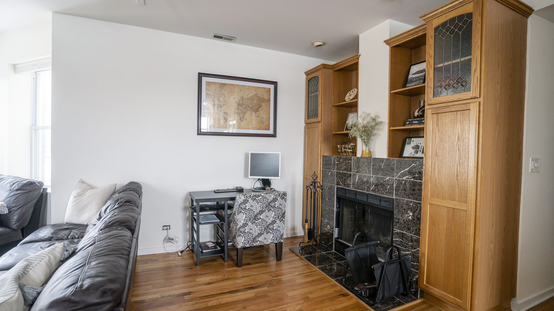 4660 North Spaulding Avenue, Unit 3 Chicago, IL 60625 - Photo 10 of 29 a living room with furniture a flat screen tv and a fireplace