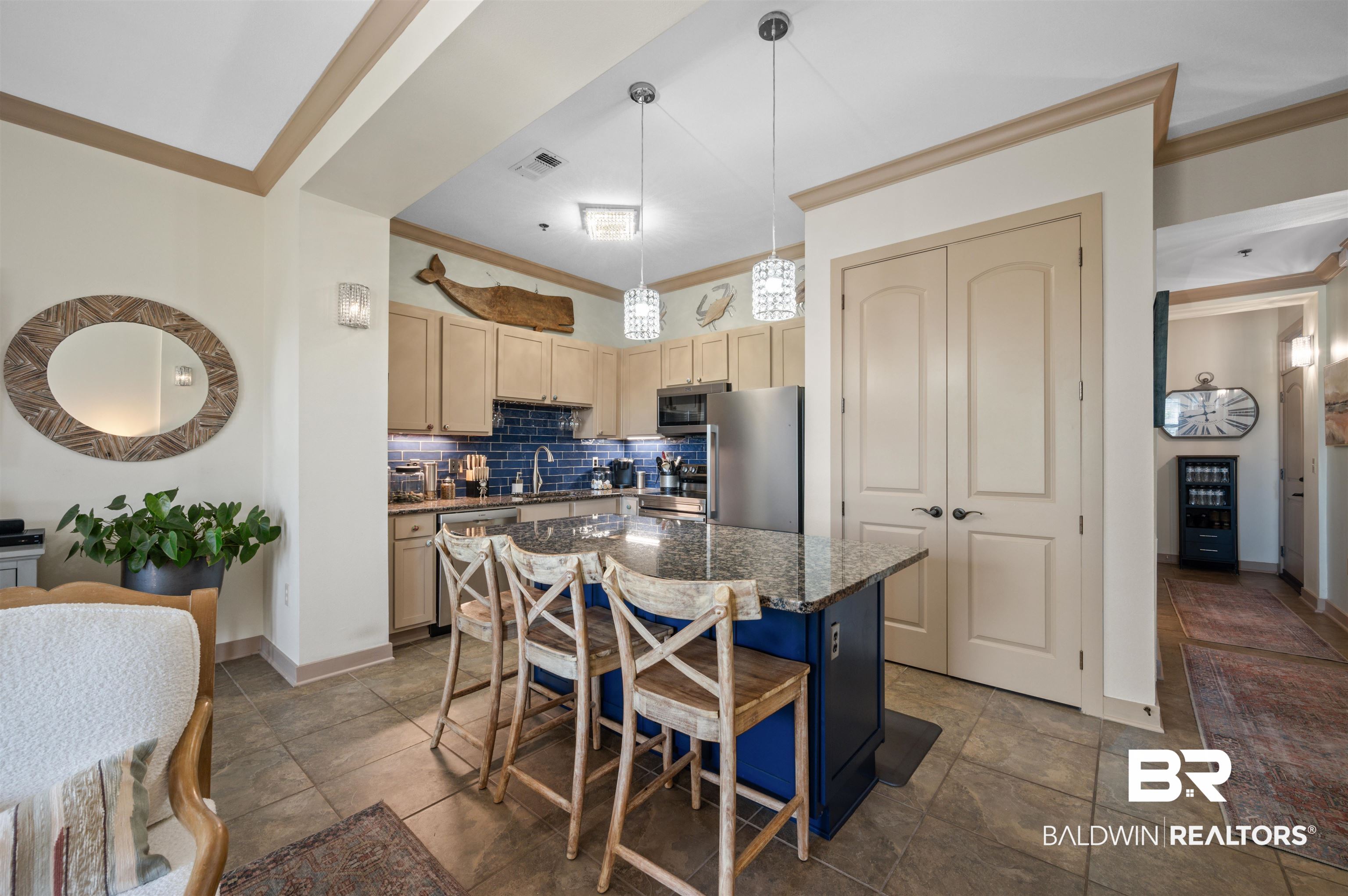 1430 Regency Road, Unit B202 Gulf Shores, AL 36542 - Photo 3 of 33 Kitchen with light brown cabinets, stainless steel appliances, a kitchen island, tasteful backsplash, and crown molding