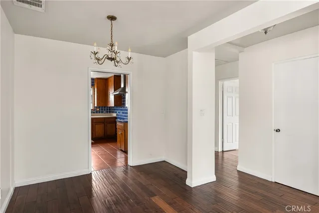 a view of a kitchen with a sink cabinets and wooden floor
