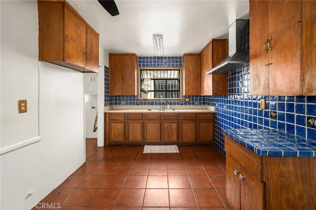 a kitchen with a stove a sink and a refrigerator