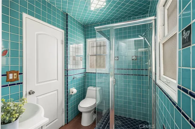 a bathroom with a toilet and shower