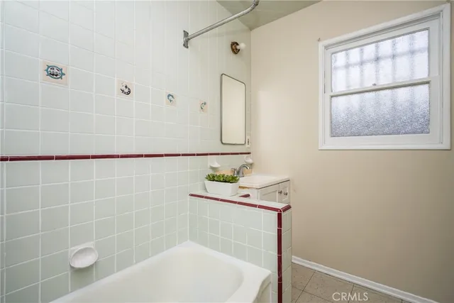 a bathroom with a sink a window and shower