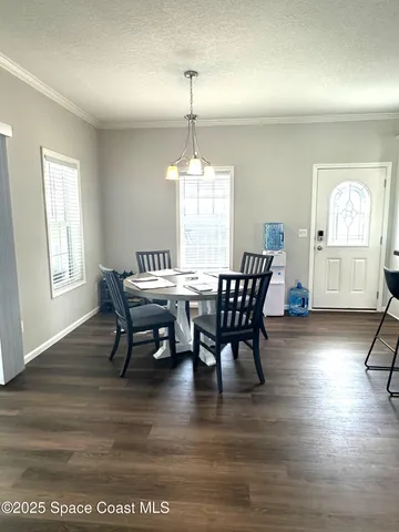 a dining room with furniture window and wooden floor