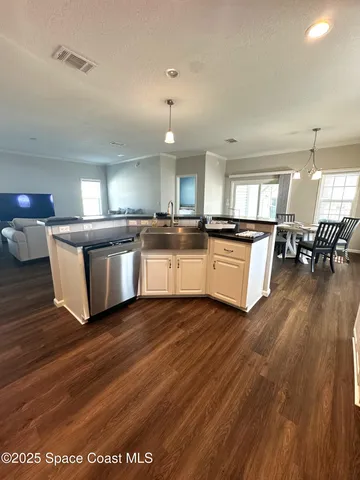 a kitchen with stainless steel appliances granite countertop a stove and a wooden floors