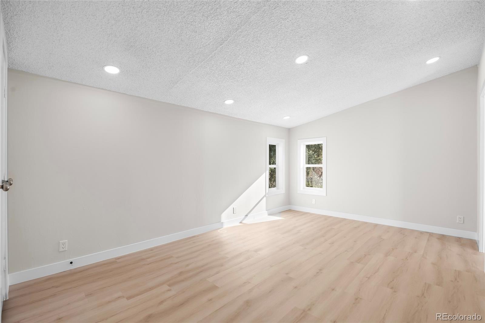 197 Pinto Street Golden, CO 80401 - Photo 11 of 19 a view of an empty room with wooden floor and a window