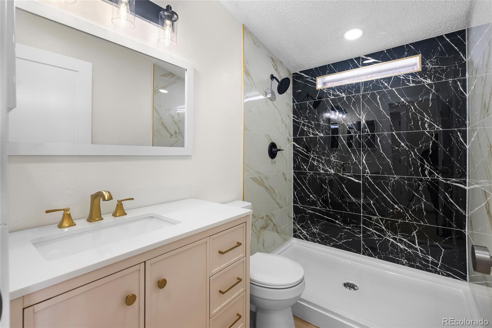 197 Pinto Street Golden, CO 80401 - Photo 13 of 19 a bathroom with a sink toilet and shower