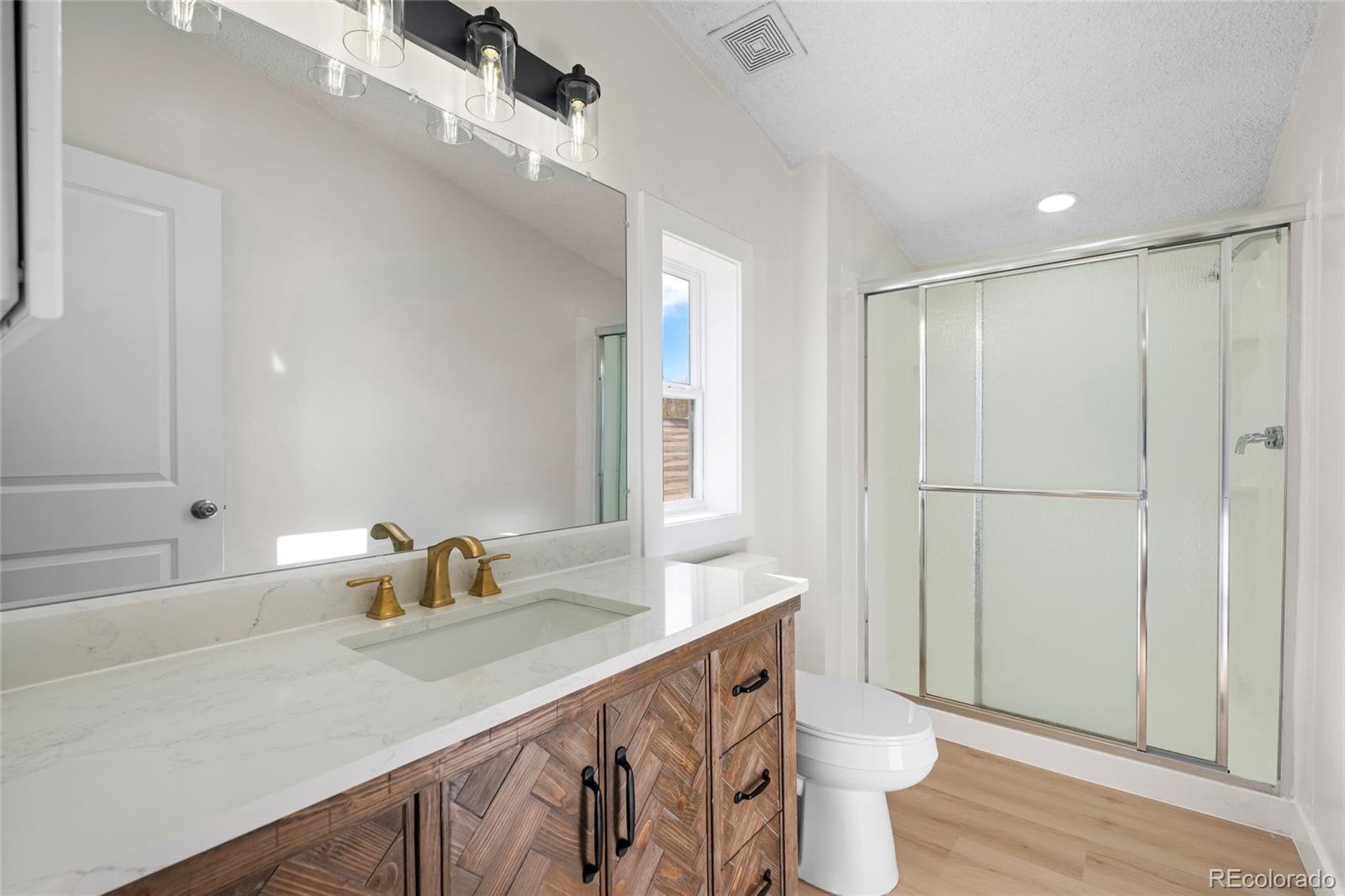 197 Pinto Street Golden, CO 80401 - Photo 15 of 19 a bathroom with a sink a toilet and shower