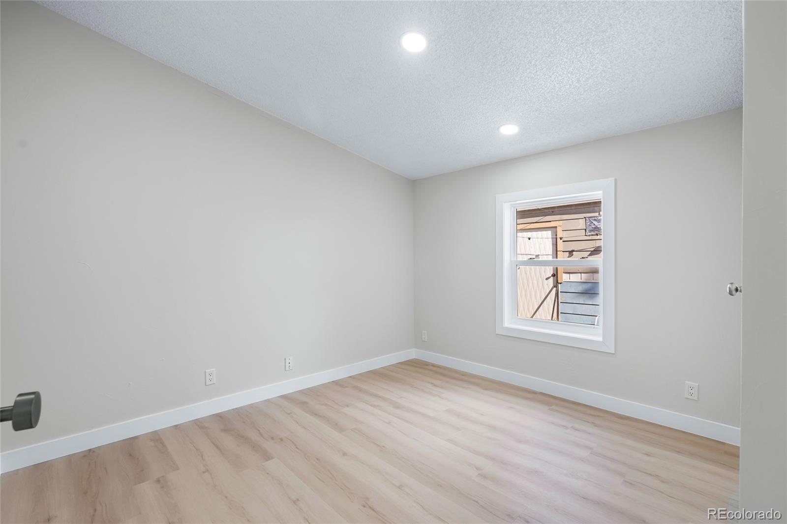 197 Pinto Street Golden, CO 80401 - Photo 16 of 19 an empty room with wooden floor and windows
