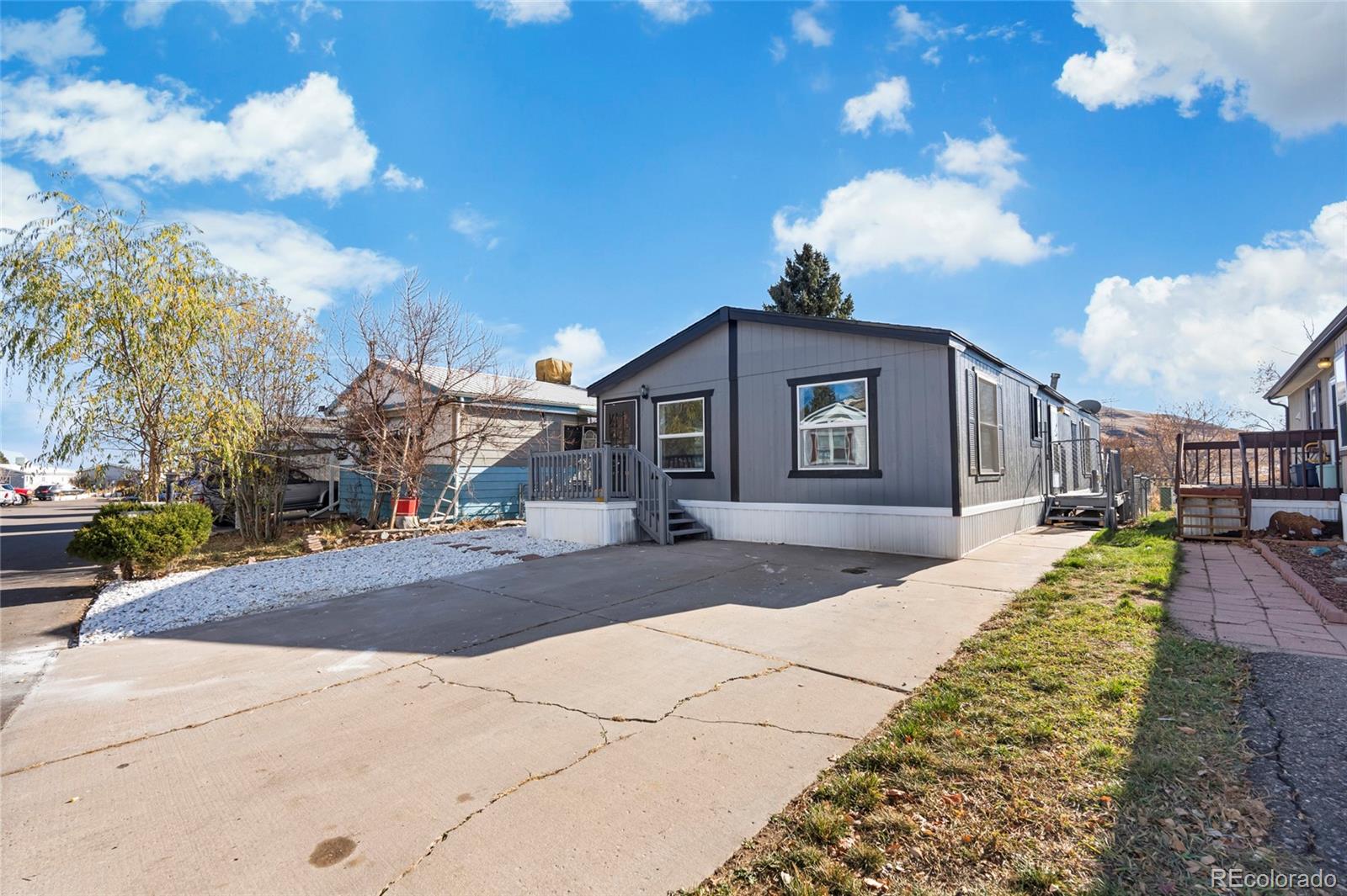 197 Pinto Street Golden, CO 80401 - Photo 2 of 19 a front view of a house with a yard and garage