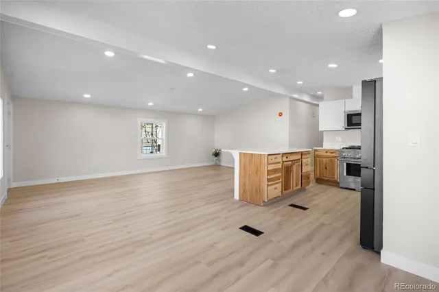 a view of kitchen with cabinets and wooden floor