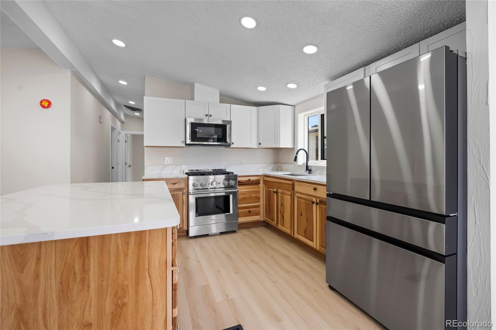 197 Pinto Street Golden, CO 80401 - Photo 5 of 19 a kitchen with stainless steel appliances a refrigerator sink and microwave