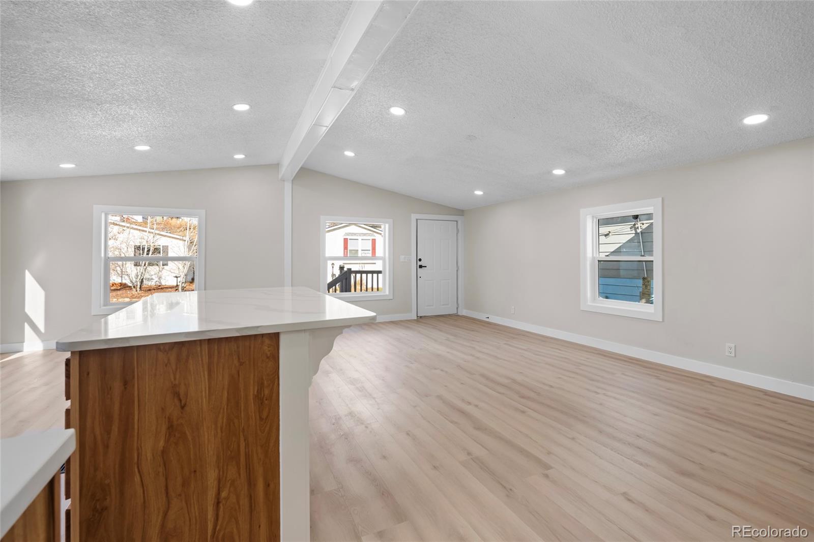 197 Pinto Street Golden, CO 80401 - Photo 6 of 19 an empty room with windows and entrance