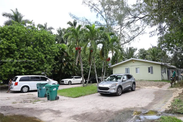 a front view of a house with cars parked