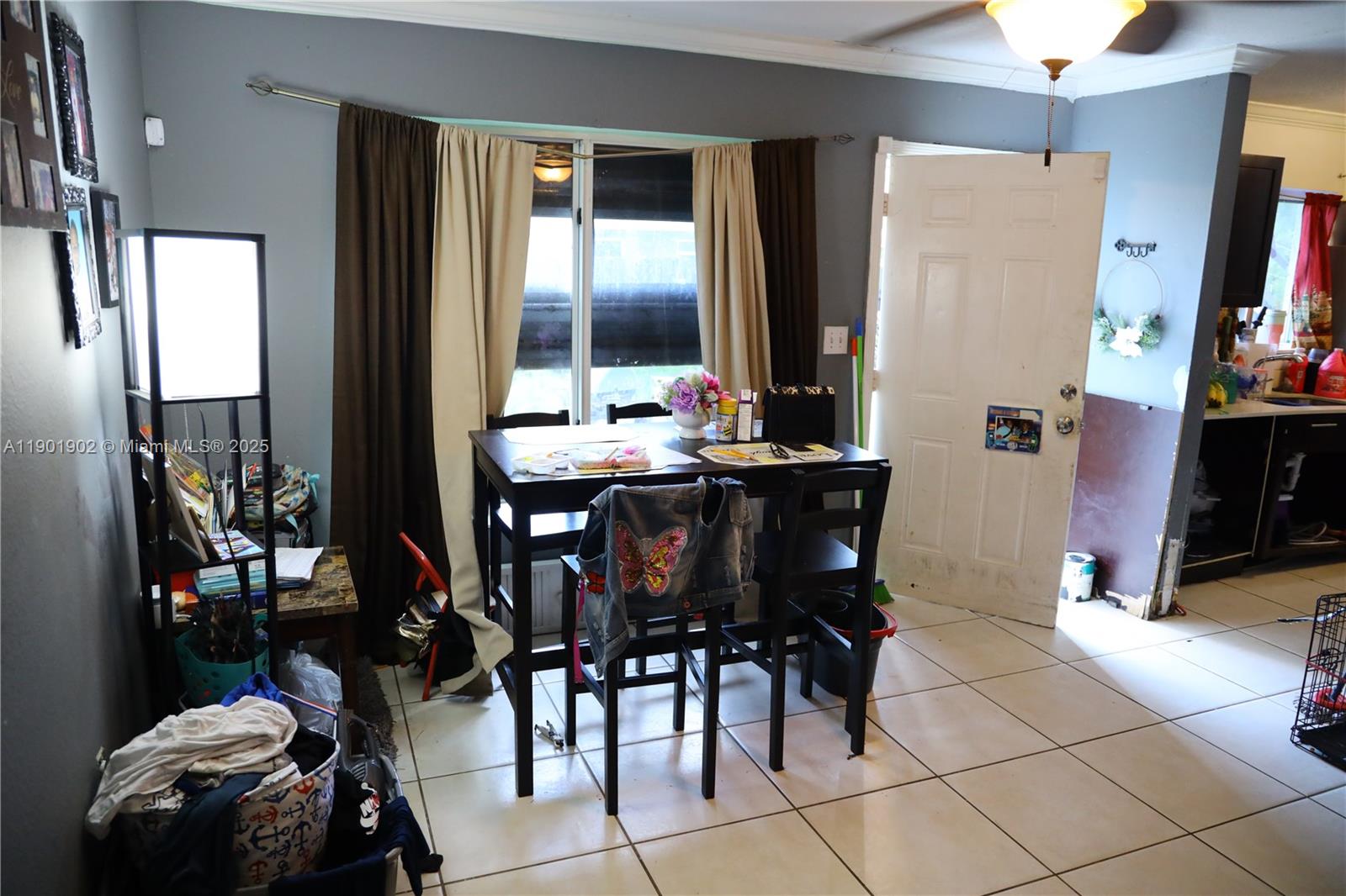 11735 Northwest 22nd Court Miami, FL 33167 - Photo 4 of 11 a view of a dining room with furniture and chandelier