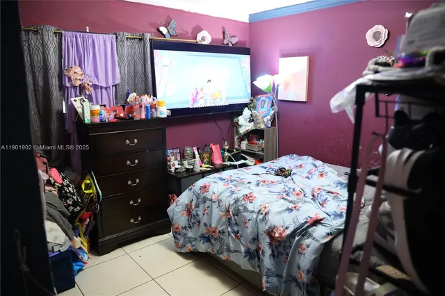 a bed room with a bed and a tv