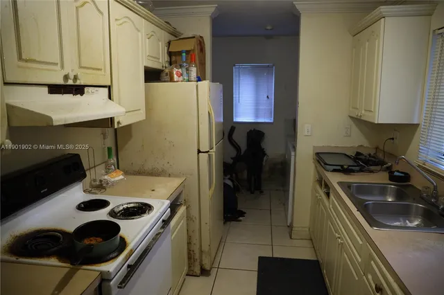 a kitchen with a sink stove and refrigerator