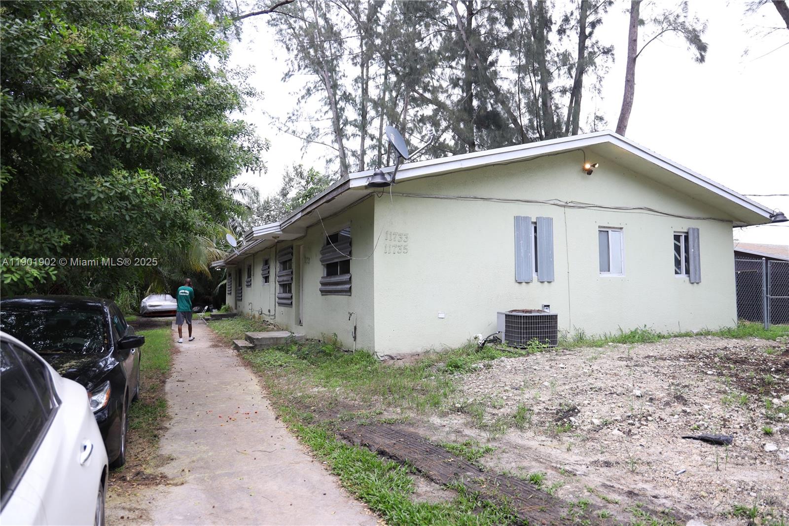 11735 Northwest 22nd Court Miami, FL 33167 - Photo 9 of 11 a backyard of a house with yard and large trees