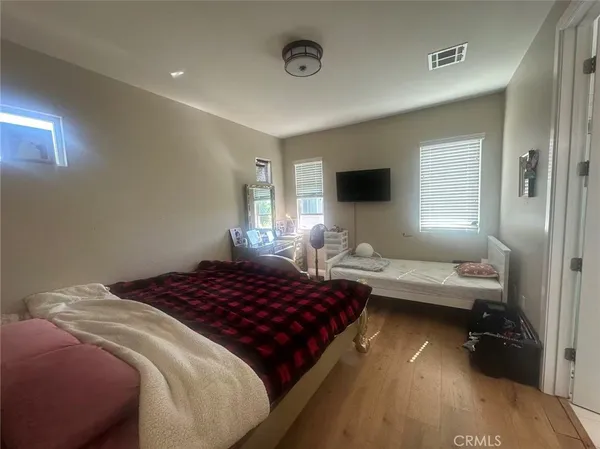 a bedroom with a bed and a flat screen tv