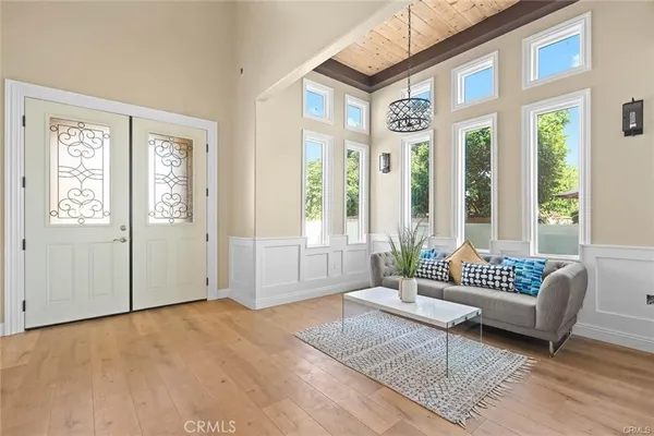 a living room with furniture and a floor to ceiling window