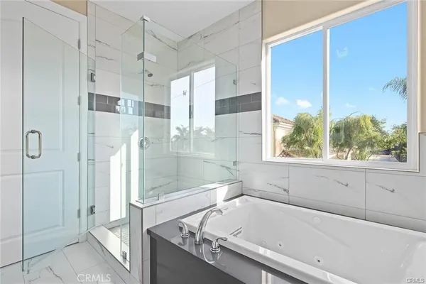 a bathroom with a tub and shower