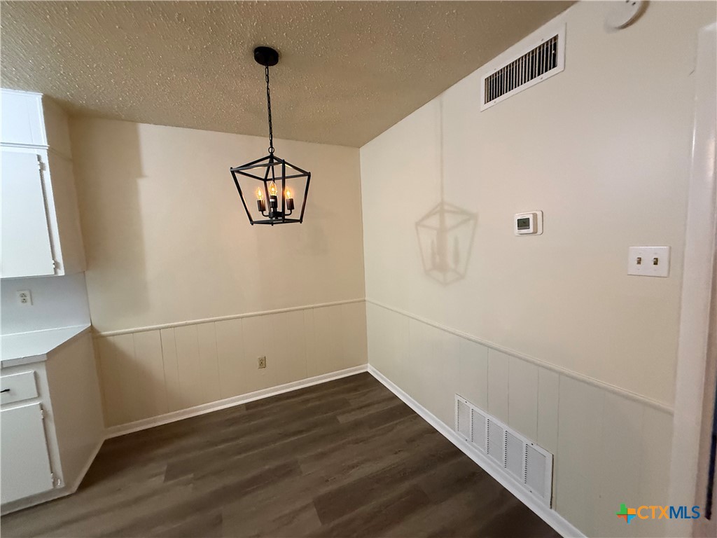 2902 Lake Road, Unit 5 Killeen, TX 76543 - Photo 3 of 5 a view of a room with wooden floor and white walls