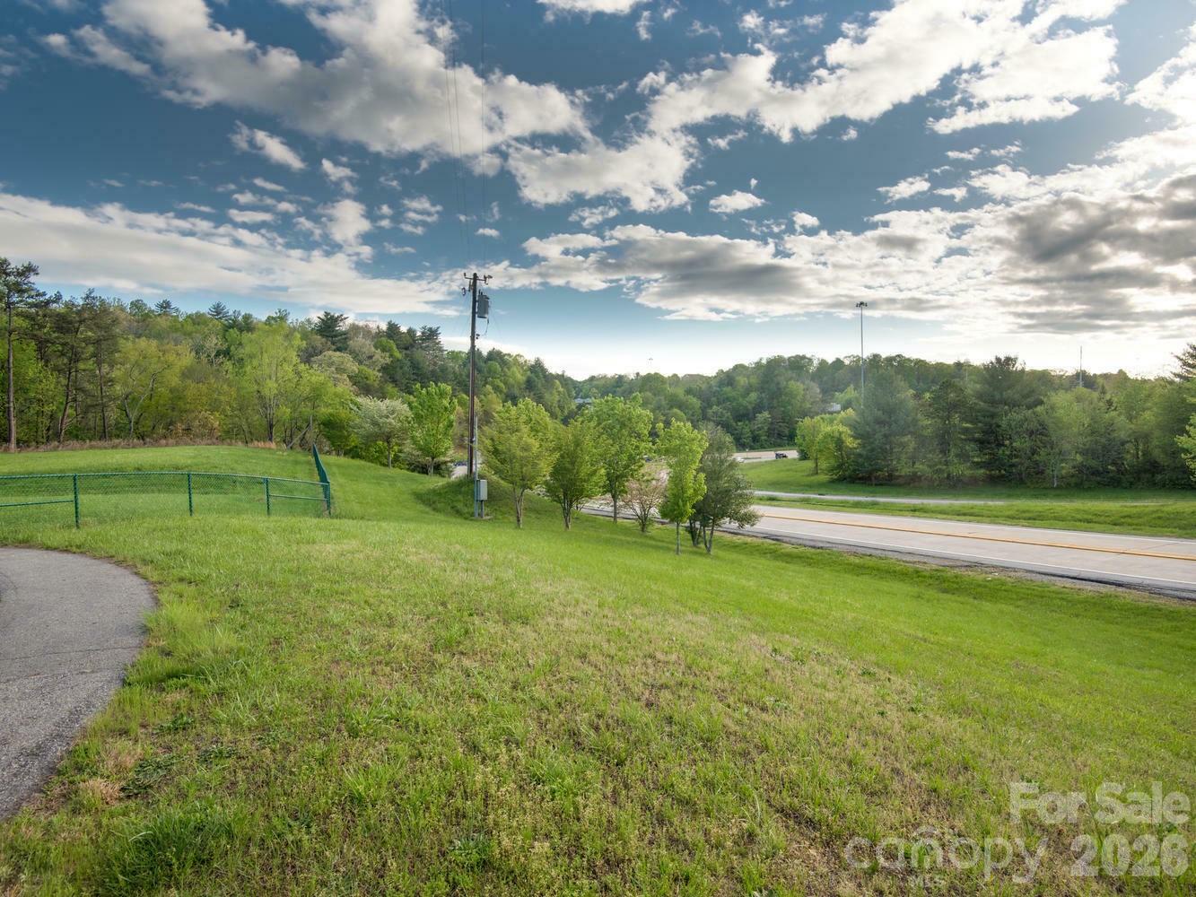 303 Gashes Creek Road Asheville, NC 28803 - Photo 10 of 15 a view of a golf course with a lake