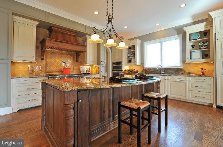 2023 Rockingham Street McLean, VA 22101 - Photo 22 of 29 a kitchen with stainless steel appliances granite countertop wooden floors and white cabinets
