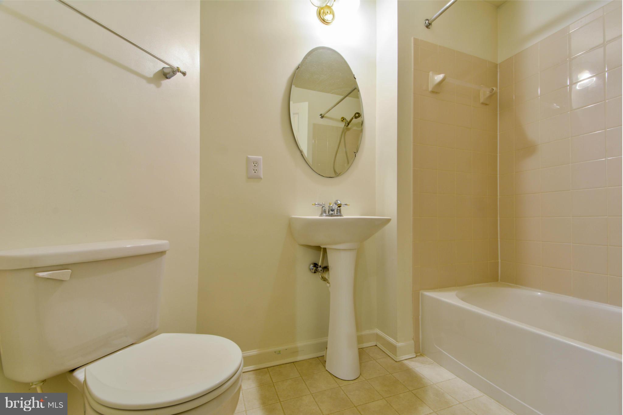 1447 Pangbourne Way Hanover, MD 21076 - Photo 17 of 30 a bathroom with a sink a toilet and bathtub